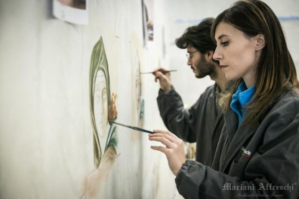 Students of the Mariani Affreschi Academy add the finishing touches to a fresco painting