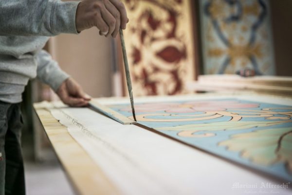 Some finishing touches are made on the fresco before it is shipped to the customer